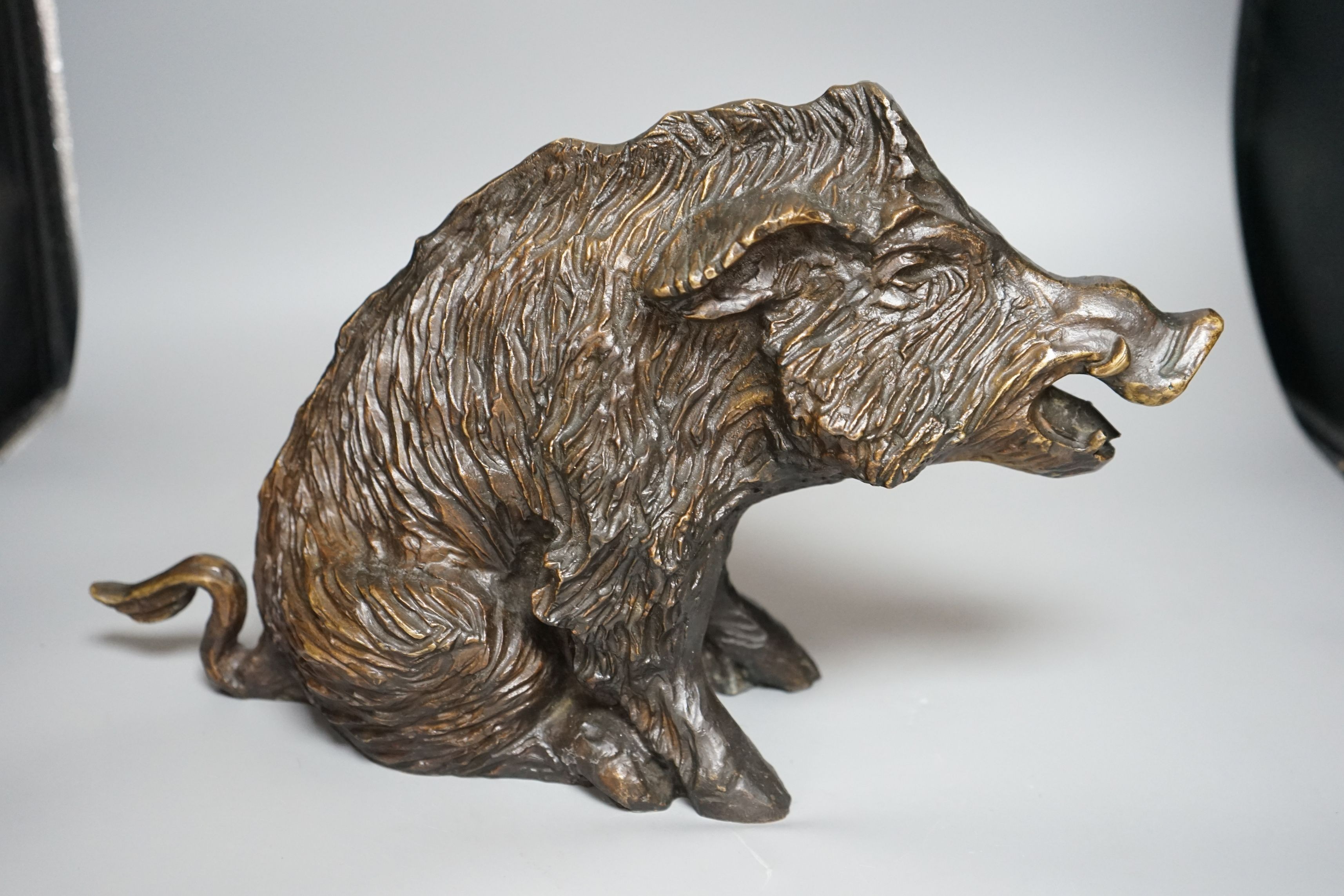 A 20th century cast bronze model of a seated boar, numbered ‘14’, height 24cm